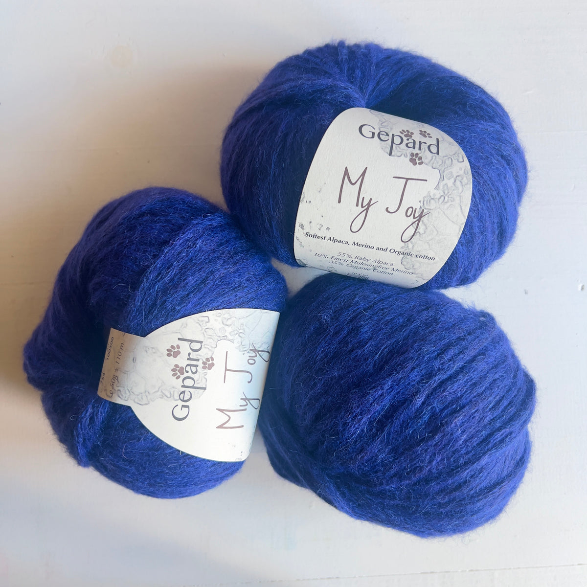 754 Ultra Blue: Three balls of Gepard My Joy yarn in 754 Ultra Blue, a vivid blue shade