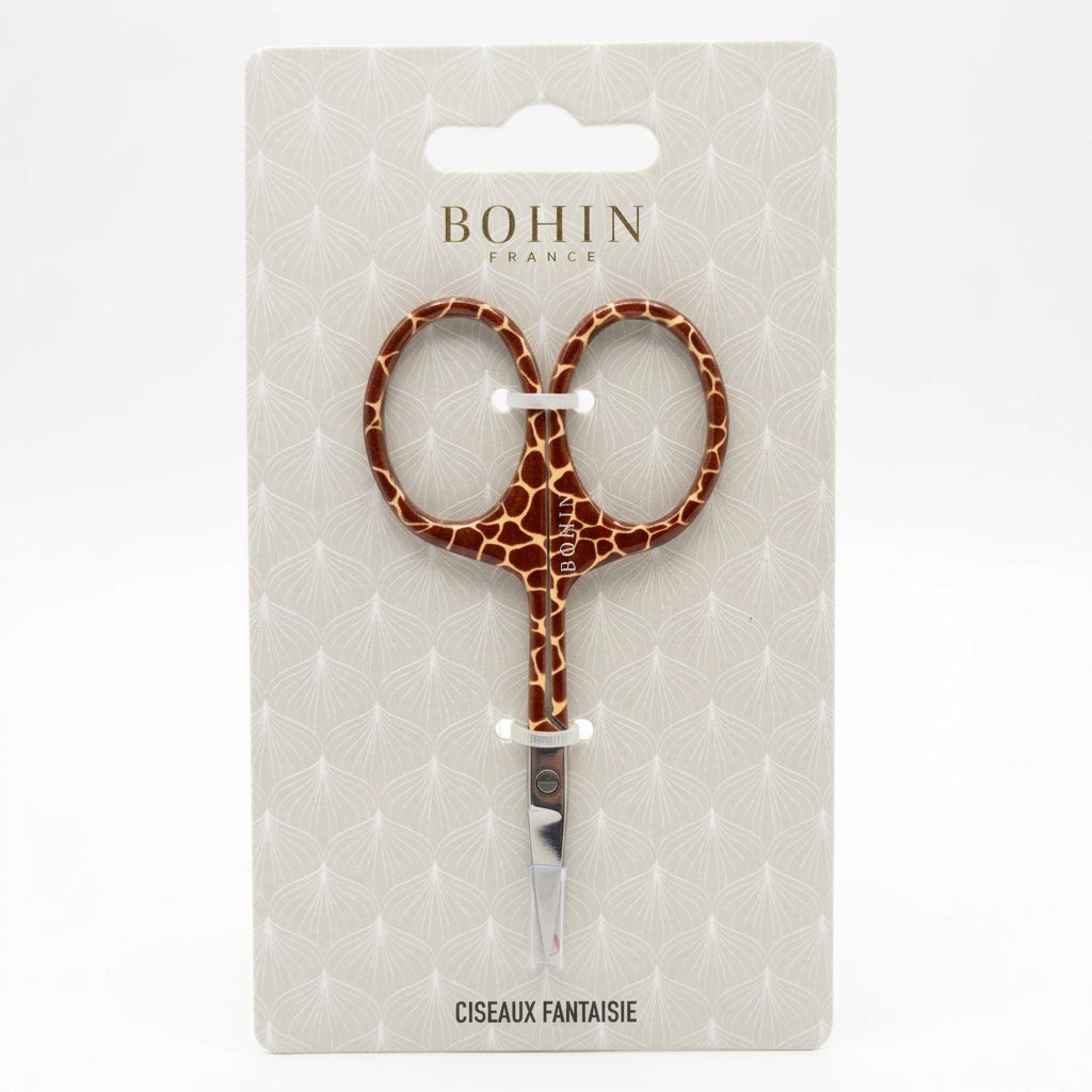a scissor with giraffe print