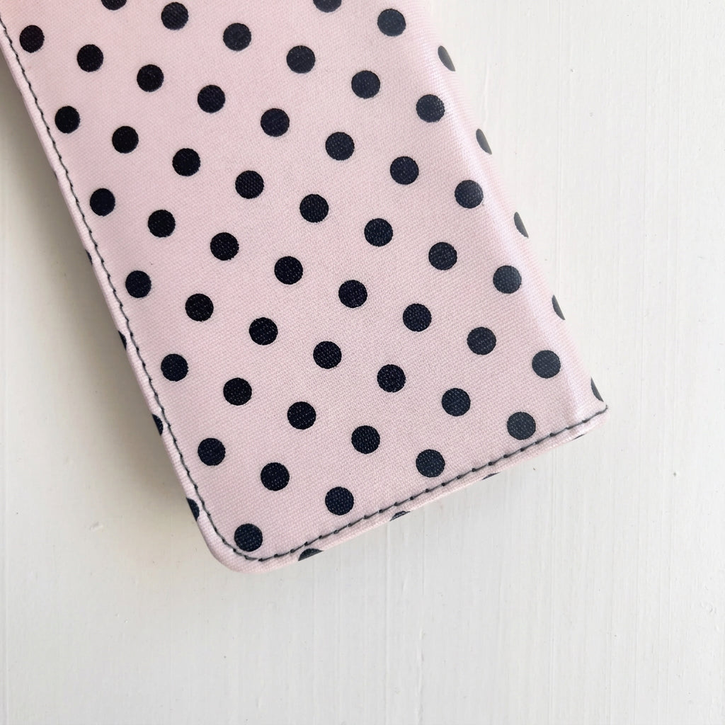 a pink and black dots case for crochet needles